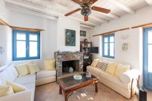 a living room with a couch and a fireplace at Marpissa Paros house Casa Mira in Kampos Paros