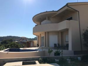 a large house with a swimming pool in front of it at Apartments Melisa in Ulcinj