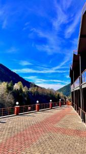 a bridge with a mountain in the background at Green Cinar Apart in Uzungöl