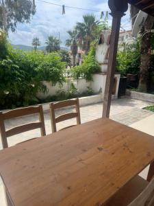 a wooden table and two chairs on a patio at Nova Aparts in Akyaka