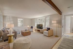 a large living room with a bed and a television at Short walk to Bayside Beach in Eastham