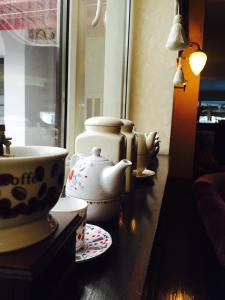 a table with a tea pot and cups on it at Matrix Hotel in Tecuci