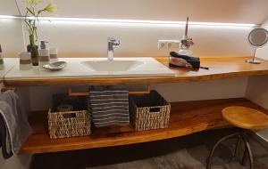 a bathroom with a sink and baskets on a counter at Ferienwohnung Oase in Peißenberg
