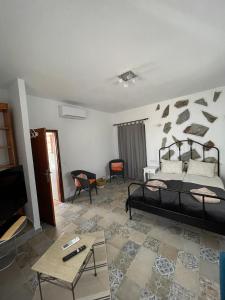 a bedroom with a bed and a living room at Strelitzia Apartament in Santa Úrsula