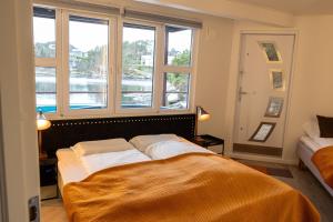 a bedroom with a bed with a large window at Floating House Bergen in Bergen