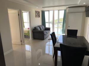 a living room with a table and a couch at Beach access apartment in Portmore