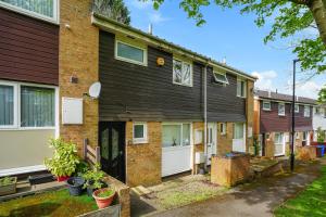 an apartment building with a garage and a driveway at Contractor accommodation in Heeley