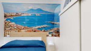 a bedroom with a view of the ocean and mountains at Vesuvius Home in Naples