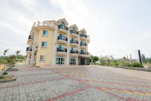 a large building with a brick driveway in front of it at Island on the Sea in Kenting