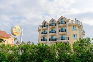 a yellow building with a sign in front of it at Island on the Sea in Kenting