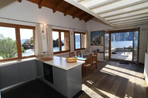 a kitchen and dining room with a view of the ocean at BellaIseo Luxury rooftop in Pilzone