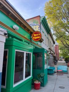 a green building with a sign on it on a street at Good Night Sleep 1Bdrm 2 Queen Beds in Washington