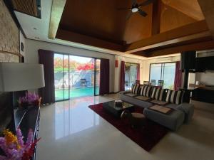 a living room with a couch and a table at Lris villas in Phuket Town