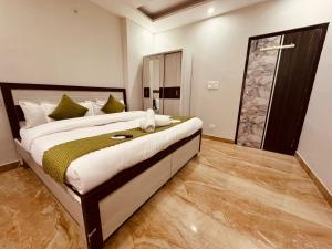 a bedroom with a large bed and a sliding glass door at Aston Hills Rooms & Cottages Tapovan in Rishīkesh