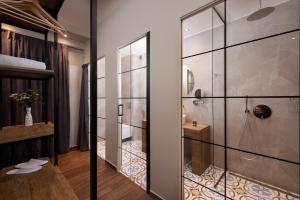 een badkamer met een douche en een glazen deur bij Hotel Naiades in Órma