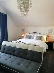 um quarto com uma cama grande e um lustre em HARBOUR VIBES em Weymouth