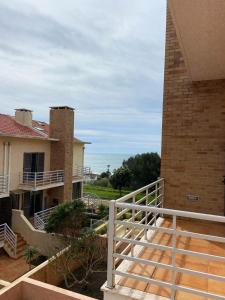 a balcony of a house with a view of the ocean at Maura's Holiday House in Silveira
