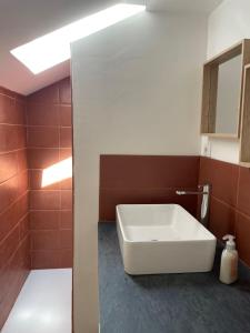 a bathroom with a white tub and a sink at La maison du jardin in Saint-Jean-de-Luz +15 photos