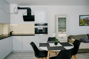 a kitchen and living room with a table and chairs at Apartament Reda in Reda