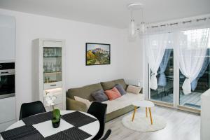 a living room with a couch and a table at Apartament Reda in Reda
