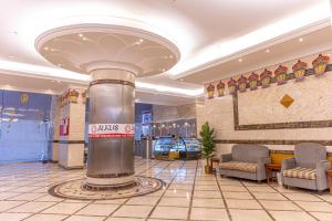 een lobby met een zuil in het midden van een gebouw bij Hotel Apartments in Mekka