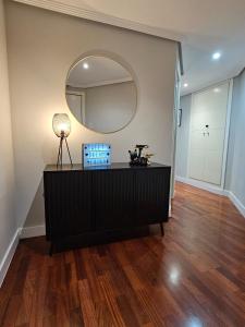 a living room with a mirror and a dresser at Sweet Dreams Ebora in Talavera de la Reina +22 photos