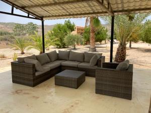 a couch sitting under a pavilion in the desert at Casita Abanilla in Murcia