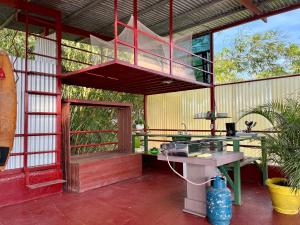 a house with a balcony with a desk and a table at Villas Jacquelina in Quepos