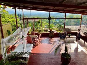 a balcony with plants and a view of the mountains at Villas Jacquelina in Quepos