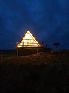 a large glass house lit up at night at Fazenda Invernada Grande Turismo Rural in Bom Jardim da Serra