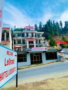 a large hotel with a sign in front of it at LeGrand Hotel & Resort in Swat