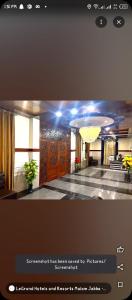 een foto van een lobby met een kamer met houten deuren bij LeGrand Hotel & Resort in Swat