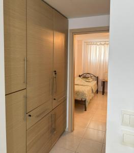 a bedroom with wooden cabinets and a bed in a room at Antoaneta's apartment in Kalamitsi
