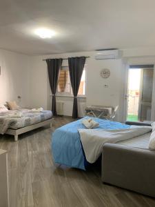 a bedroom with two beds and a window at Casa di Nonna Checca in Leuca