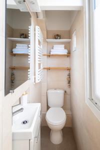 a small bathroom with a toilet and a sink at Escapade à Sanary au Cœur du Village in Sanary-sur-Mer