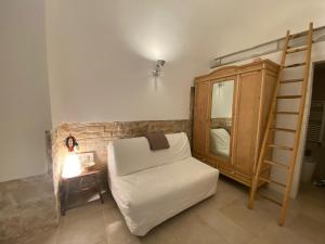 a living room with a white couch and a dresser at Old Town Moschetti 20 in Corato