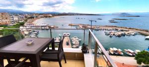 a balcony with a table and a view of a marina at Panoramic Sea View in Chania Town