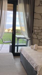 a bedroom with a bed and a window with a view at Afytos sea view in Afitos