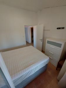 1 dormitorio con cama blanca y armario en Apartmani Manda Nin - Sabunike, en Nin