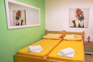 a bedroom with two beds and a mirror at Studios Lavender in Split