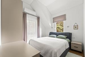 帕兰加Vytauto 226的一间带床和窗户的白色卧室