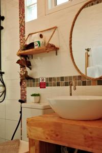 een badkamer met een wastafel en een spiegel bij Sea Dreamer Beachfront Apartments in Phuket