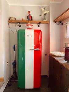 a green red and white refrigerator in a kitchen at B&B Al Castello Sweethome in Parma