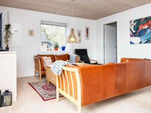 a living room with a couch and a table at 6 person holiday home in B rkop in Børkop