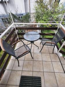 two chairs and a table on a patio at Seaside Apartment Bubi in Crikvenica