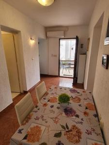 a dining room with a table with a flower pattern on it at Seaside Apartment Bubi in Crikvenica
