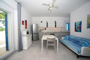 a kitchen with a table and a bed in a room at Marco Polo 30 in Porto Recanati