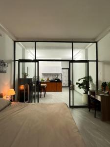 a bedroom with a bed and a dining room at Calmette Home in Ho Chi Minh City