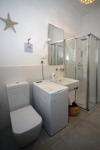 een badkamer met een toilet, een wastafel en een spiegel bij Marco Polo 30 in Porto Recanati