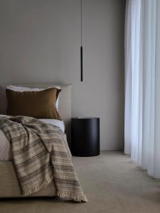 a bedroom with a bed and a table and curtains at Bond Smart Living Suites in Athens